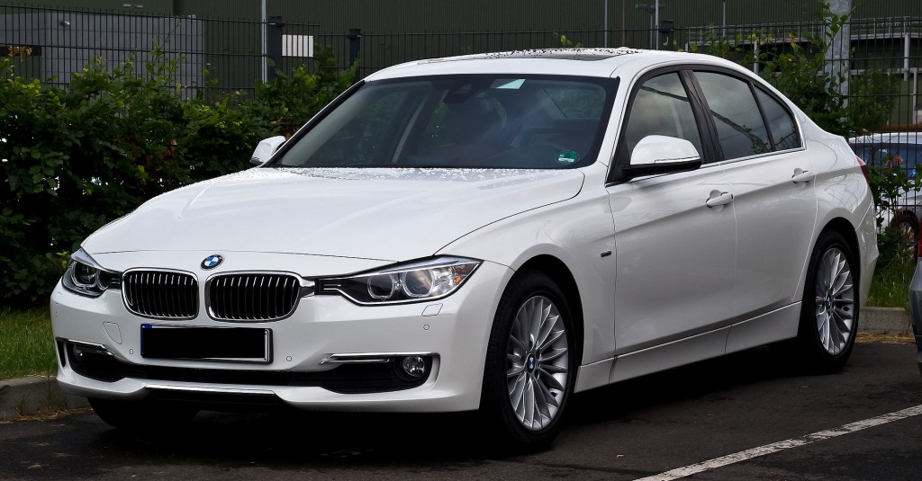 White 2012 BMW 320d in parking lot