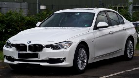 White 2012 BMW 320d in parking lot